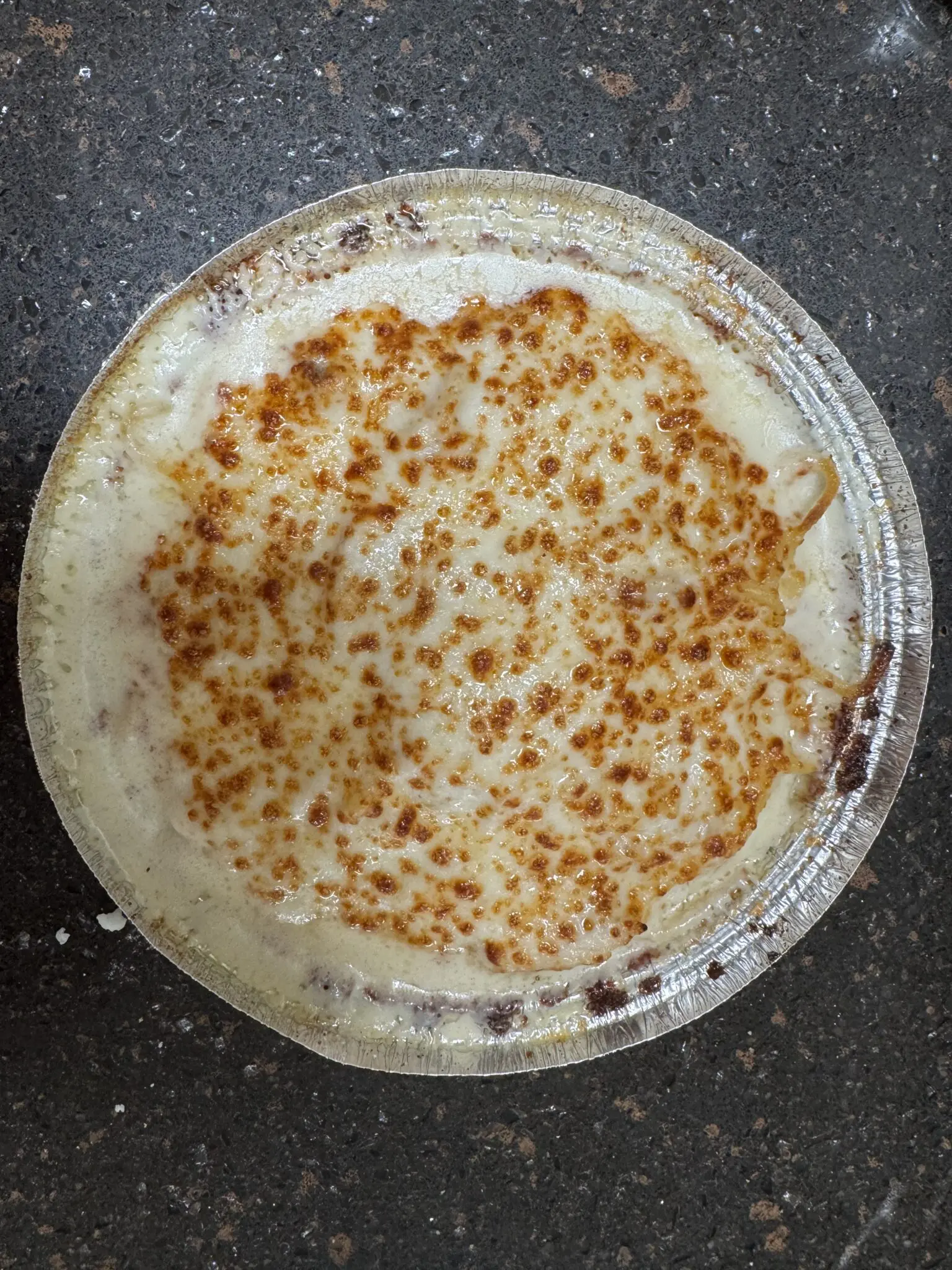 A close-up of a traditional flatbread with toasted spots on top.