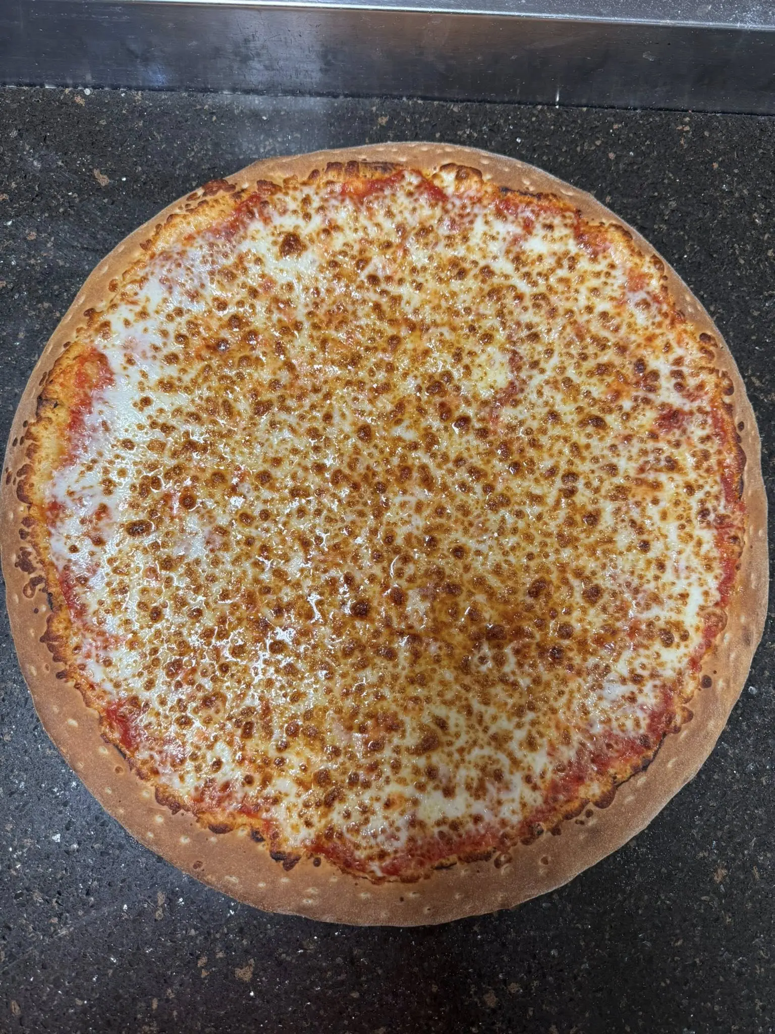 A whole cheese pizza with a golden-brown crust.