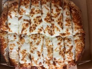 Close-up of cheesy, rectangular pizza slices.