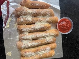 Freshly baked breadsticks sprinkled with parmesan cheese, served with marinara sauce.