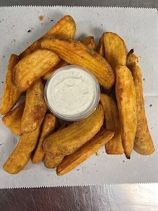 Thick, golden fried potato wedges with a creamy dipping sauce.