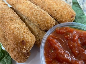 Crispy breaded mozzarella sticks with marinara sauce.