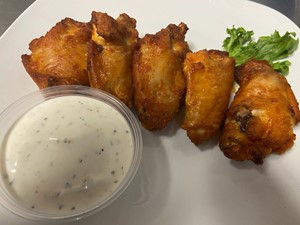 Crispy buffalo chicken wings with ranch dipping sauce.