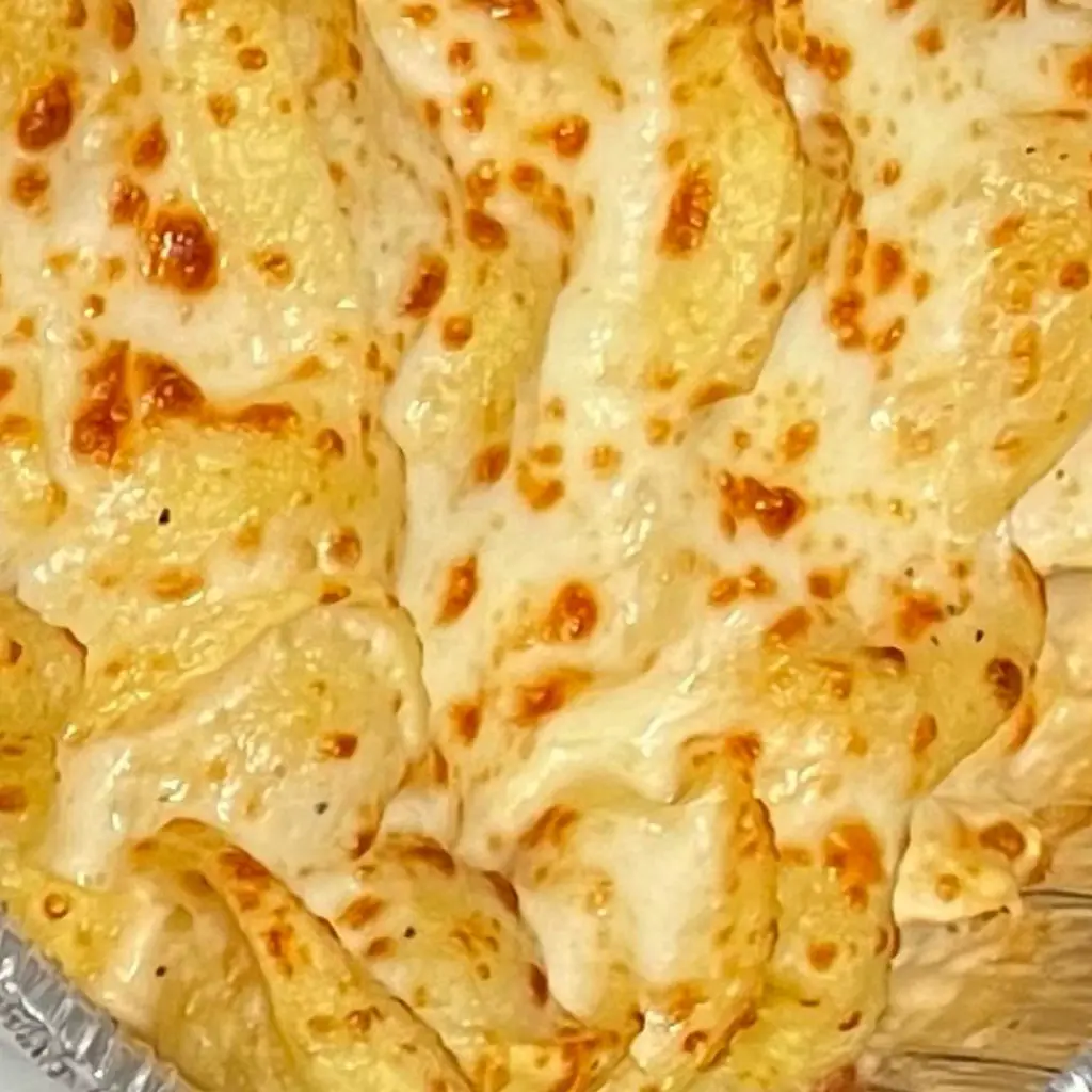 A close-up of cheesy baked pasta.