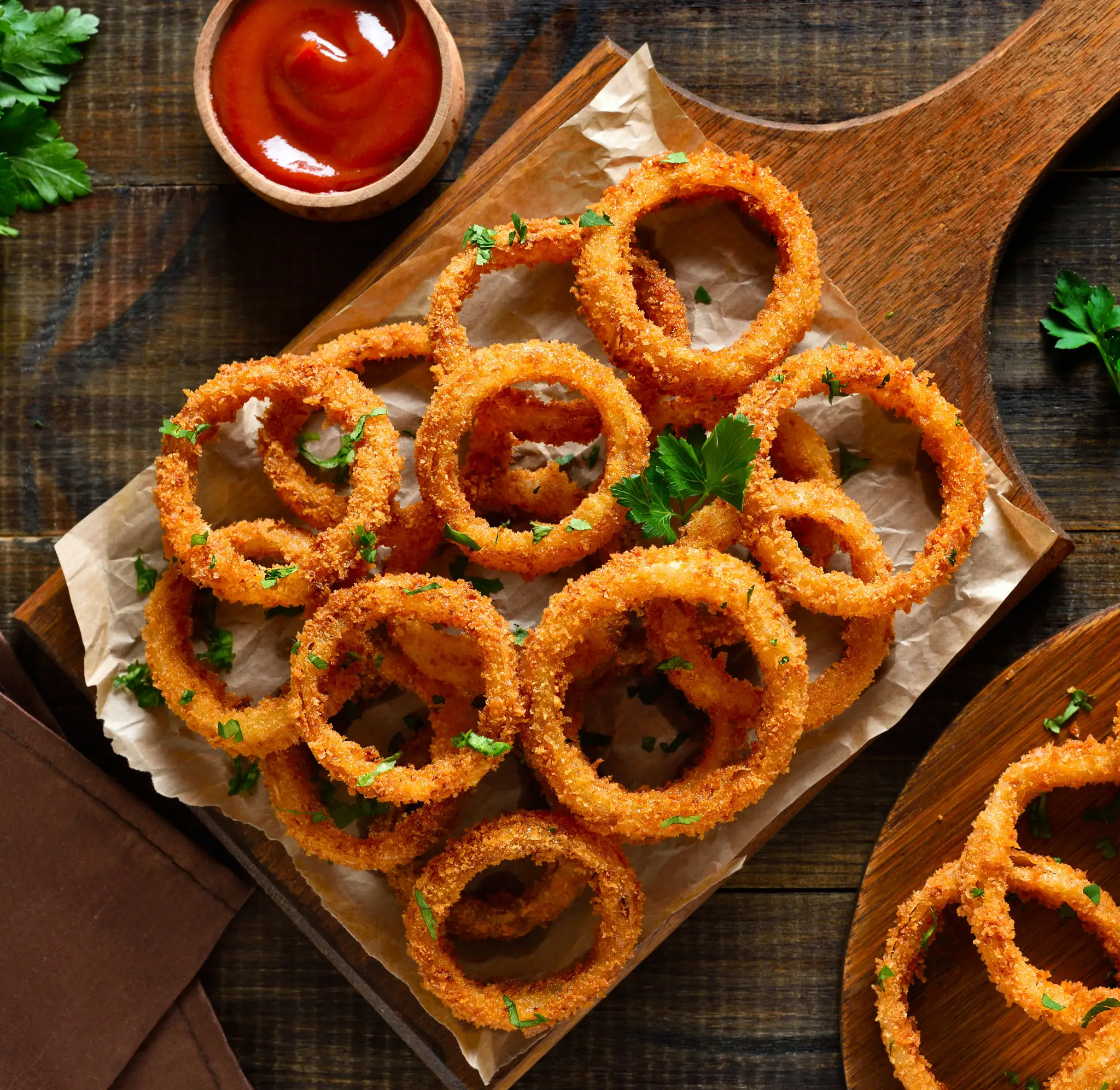 Crispy golden onion rings served with ketchup.