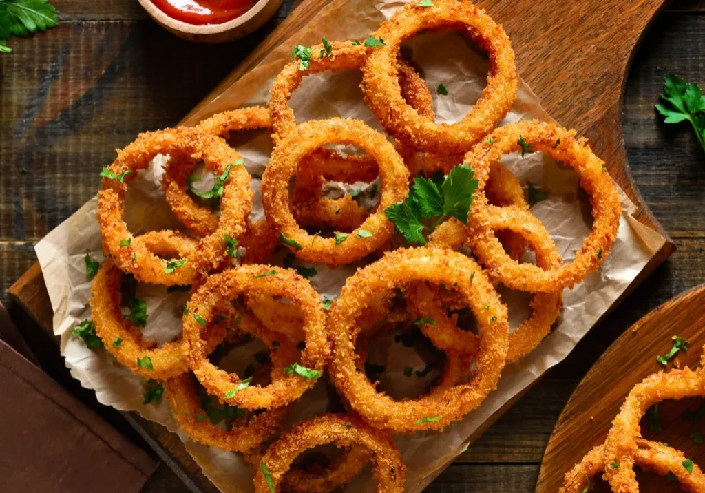 Crispy golden onion rings served with ketchup.