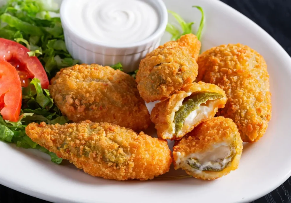 Crispy fried jalapeño poppers with dipping sauce.