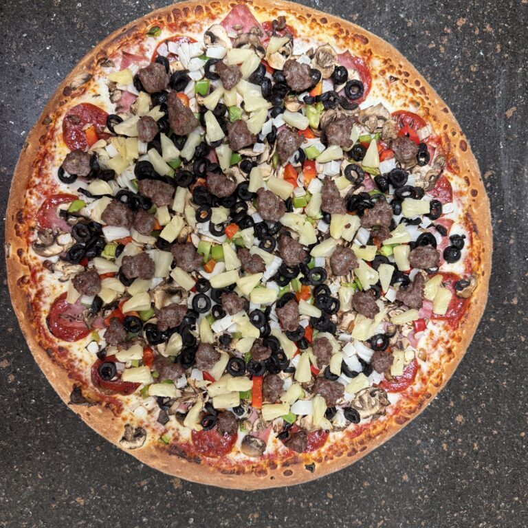 A freshly baked pizza topped with olives, mushrooms, and cheese.