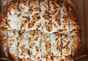 Close-up of cheesy, rectangular pizza slices.