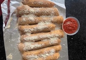 Freshly baked breadsticks sprinkled with parmesan cheese, served with marinara sauce.