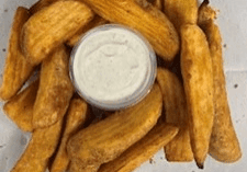 Thick, golden fried potato wedges with a creamy dipping sauce.