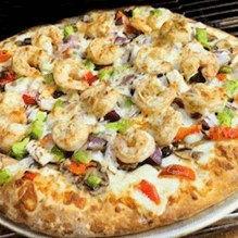 A shrimp pizza topped with vegetables and melted cheese.