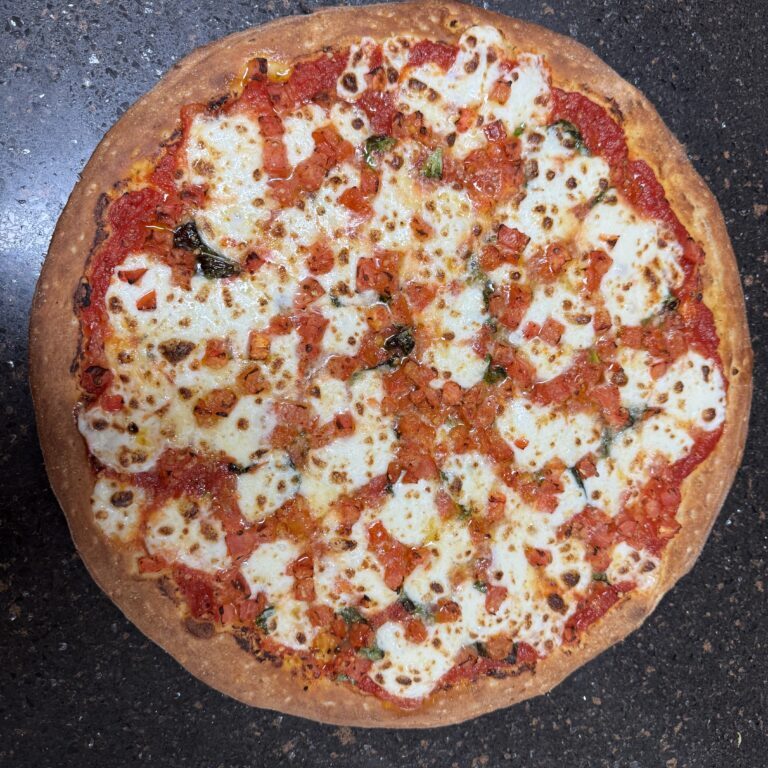 A freshly baked pizza with melted cheese and tomato sauce.