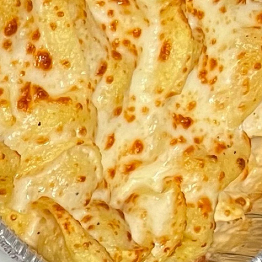 A close-up of cheesy baked pasta.